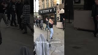 Busker sings “Read all about it” in Piccadilly london.