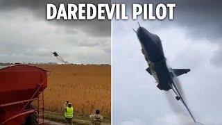 Moment hotshot Ukrainian fighter pilot flies inches above cheering onlookers in roaring low flypast