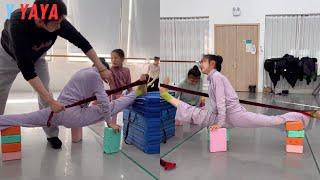 To increase flexibility, girls in a dance class perform strengthening exercises with elastic bands.