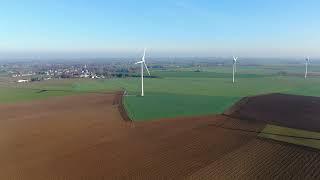 Aerial view of windmills and agricultural fields in 4K  | Free Stock Video