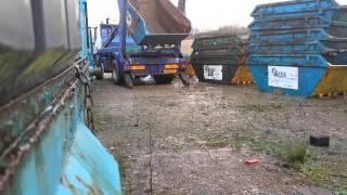 Skip lorry with skip full of water