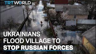 Ukrainians flood village to prevent Russian troops from passing through to Kiev