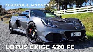 Lotus Exige 420 FE chasing a motorbike on a twisty backroad