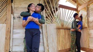 The couple's happy smile because their dream wooden house is 85% complete