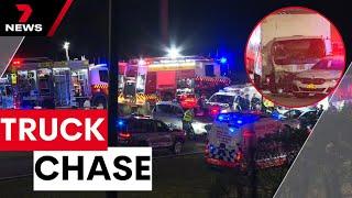 Truck driver hospitalised after smashing five police vehicles | 7NEWS