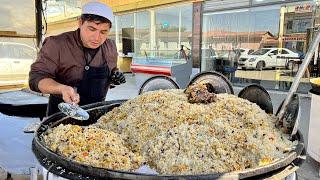 Popular Uzbek pilaf in a big pot l Street food in Uzbekistan