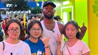 Black guy walking in China, Chinese girls surprised and want to take pictures with him.