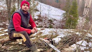 A young man's hard working day in the mountains. Harvesting firewood for the winter