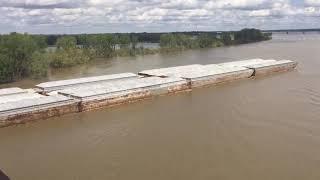 An aerial time-lapse of a towboat and barges at Memphis, TN.