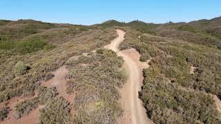 Dirt road with abandoned vehicle