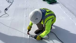 Using a Leister hand welder to seal seam of a TPO roof