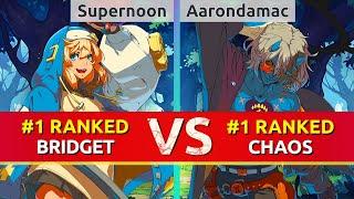 GGST ▰ Supernoon (#1 Ranked Bridget) vs Aarondamac (#1 Ranked Happy Chaos). High Level Gameplay