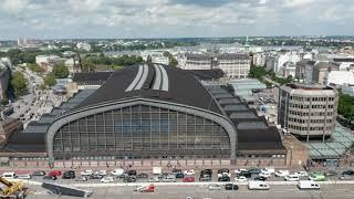 Fly around Hamburg Hauptbahnhof. Aerial view of large historical building, busy transport terminal