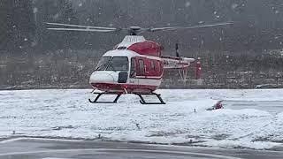 Winter landing of the Ansat medical helicopter in Helipark Podushkino in Russia