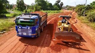 Good Skill! Powerful dozer D41a helping dump truck fail off road to move forward & pushing soil