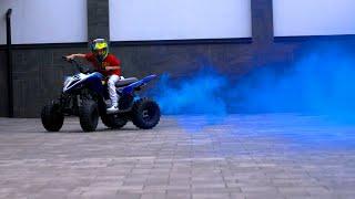 Boy Riding An ATV With Blue Smoke