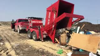 Red-E-Bins trailer dumping bin full of garbage