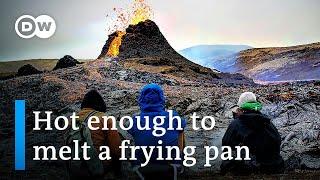 Tourists flock to Iceland volcano, cook food on lava | DW News