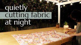 quietly cutting fabric at night on my outdoor workbench