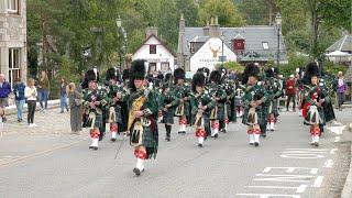 Drum Major Dean leads Huntly Pipe Band on the march to the 2023 Braemar Gathering in Scotland