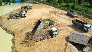 Huge land filling up, Bulldozer moving dirt, huge dump truck unloading dirt