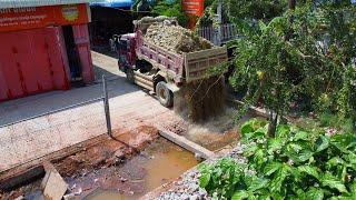 Casting stones to delete ancient pits in house fences use KOMATSU D20P dozer with dump truck unload