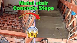 Metal stair using angle bar with concrete steps.