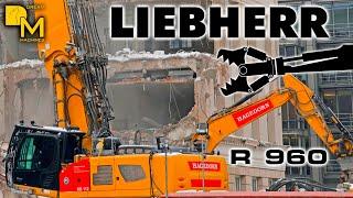 tremendous powerful Liebherr R960 high reach excavator braving tall concrete building downtown