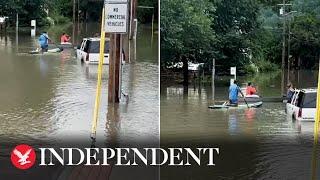 Residents kayak through flooded town as Vermont hit by severe flooding