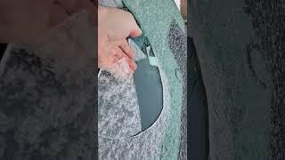 Breaking Ice off window.