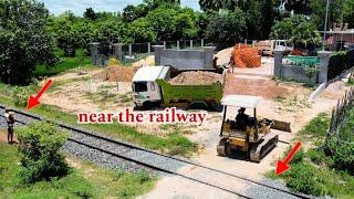 Pulling out a stuck dump truck near the railway By a driving expert and highly talented