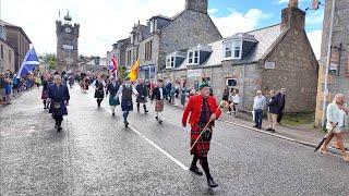 Chieftain leads the massed Pipes and Drums on the march to 2024 Dufftown Highland Games in Scotland