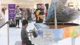 Boy Plays Piano in Major World Center