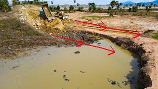 Stating New Road Construction With Old Bulldozer Komatsu D60P Pushing Big Stone And Dumping Truck