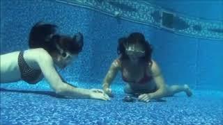 Two underwater bikini girls doing breath hold compatition