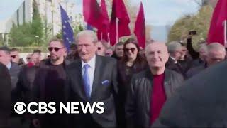 Albanian opposition leader Sali Berisha punched in the face during anti-government protest