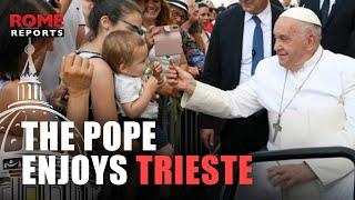 Pope Francis passes through Trieste's central square in the popemobile