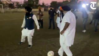 Sukhbir Badal plays a game of football with Punjab BSP chief Jasvir Singh Garhi in Phagwara