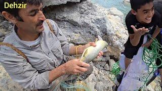 Agha Qarboun and Hossein going to the side of the roaring river and trying to fish