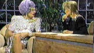 Dame Edna wearing silver dress (part 1) on Joan Rivers talk show