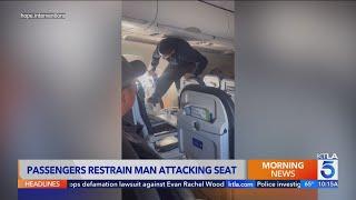 United Airlines passenger restrained after attacking own seat