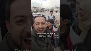 Syrian residents of Hama celebrate as rebel forces take the city