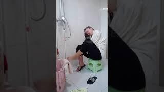 DOUBLE ABOVE ELBOW AMPUTEE LADY WASHING HAIR