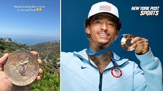 Olympics skater Nyjah Huston shows off his bronze medal but not for the right reason