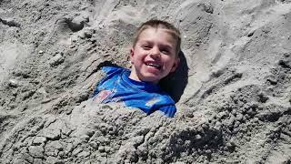 Kids Getting Buried in the Sand on Mission Beach San Diego