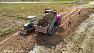 Opening a land fill site in a field by use machine mini dozer kumat’su and dump truck 5 ton