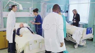 Busy Doctors And Nurses Taking Care Of Patients On A Hospital Ward. Stock Footage