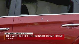 Car with bullet holes inside crime scene