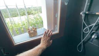 Inspecting a window in a shower.