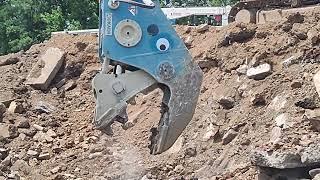 Okada pulverizer munching on concrete.